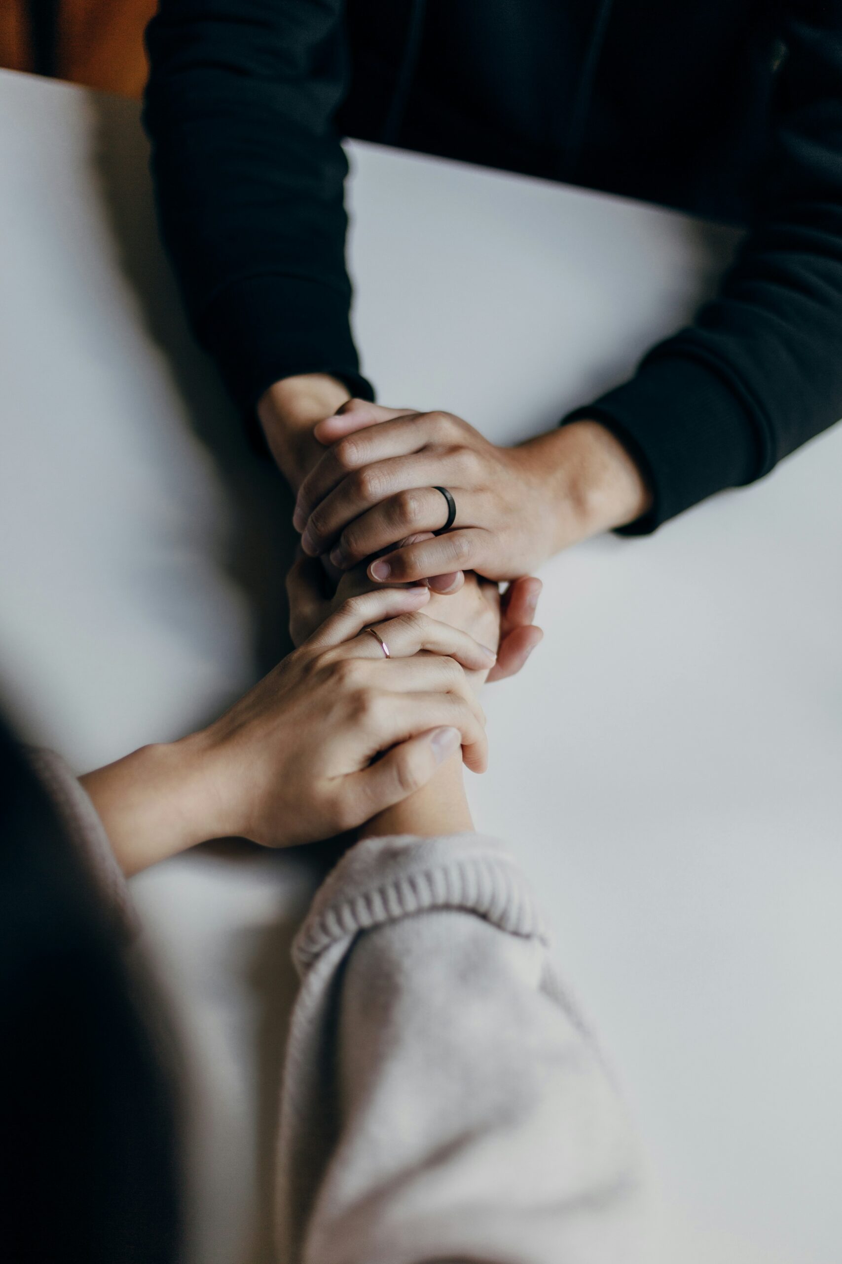 overhead photo of two people holding hands